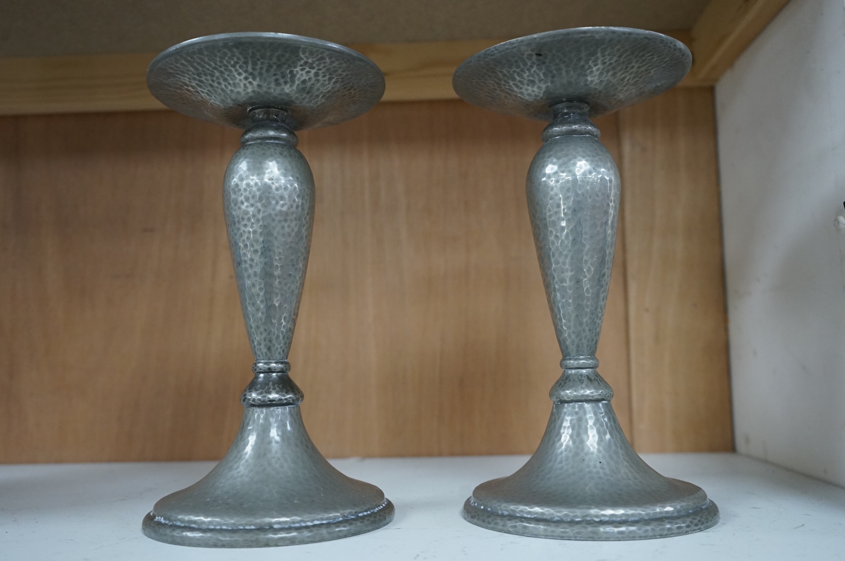 A pair of Liberty Tudric pewter candlesticks, numbered 01223 to the bases, 24cm high